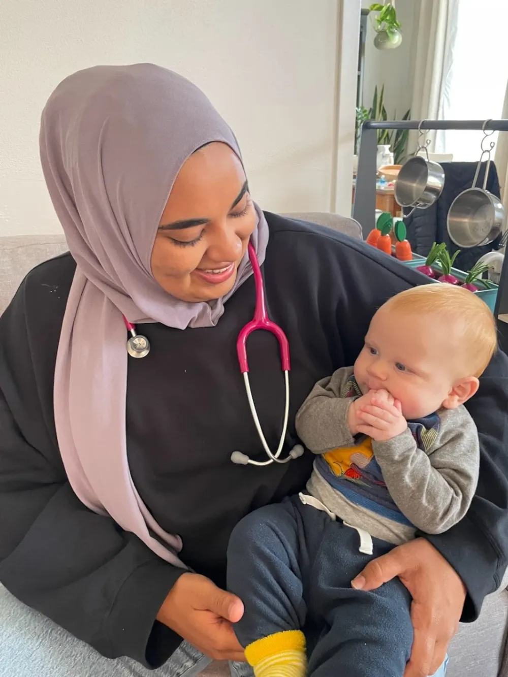 Midwife Zainab holding a baby